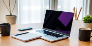 Modern workspace with laptop and notepad for startups.