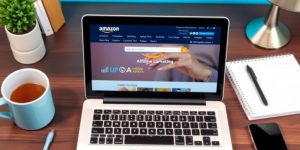 Laptop with Amazon website in a cozy workspace setting.