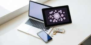 Laptop, tablet, phone, money.